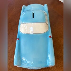 Vintage ceramic piggy bank in the shape of a classic Chevrolet Corvette.